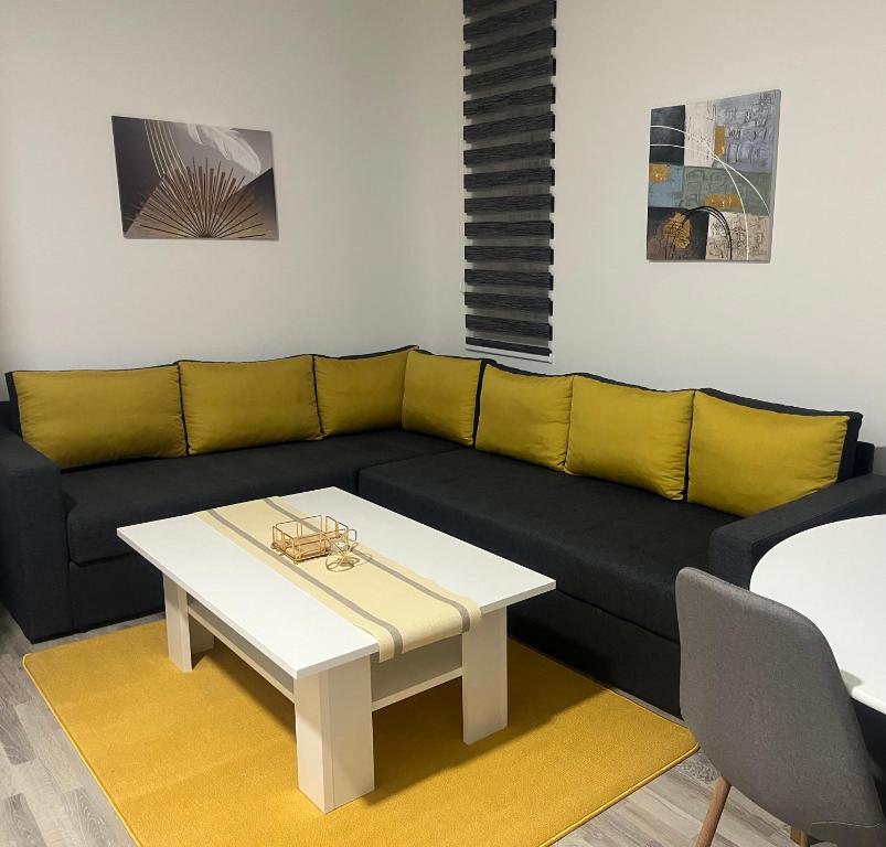 a living room with a couch and a coffee table at Apartment Grey Deluxe in Sarajevo