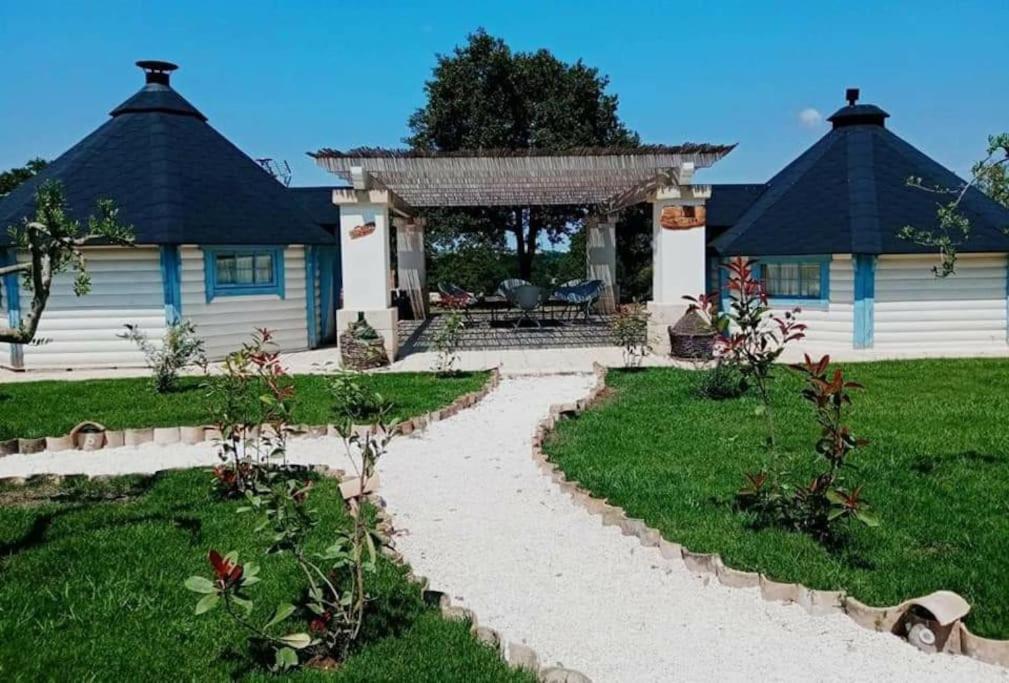 een huis met een loopbrug voor een tuin bij Trullo Iris in Cisternino