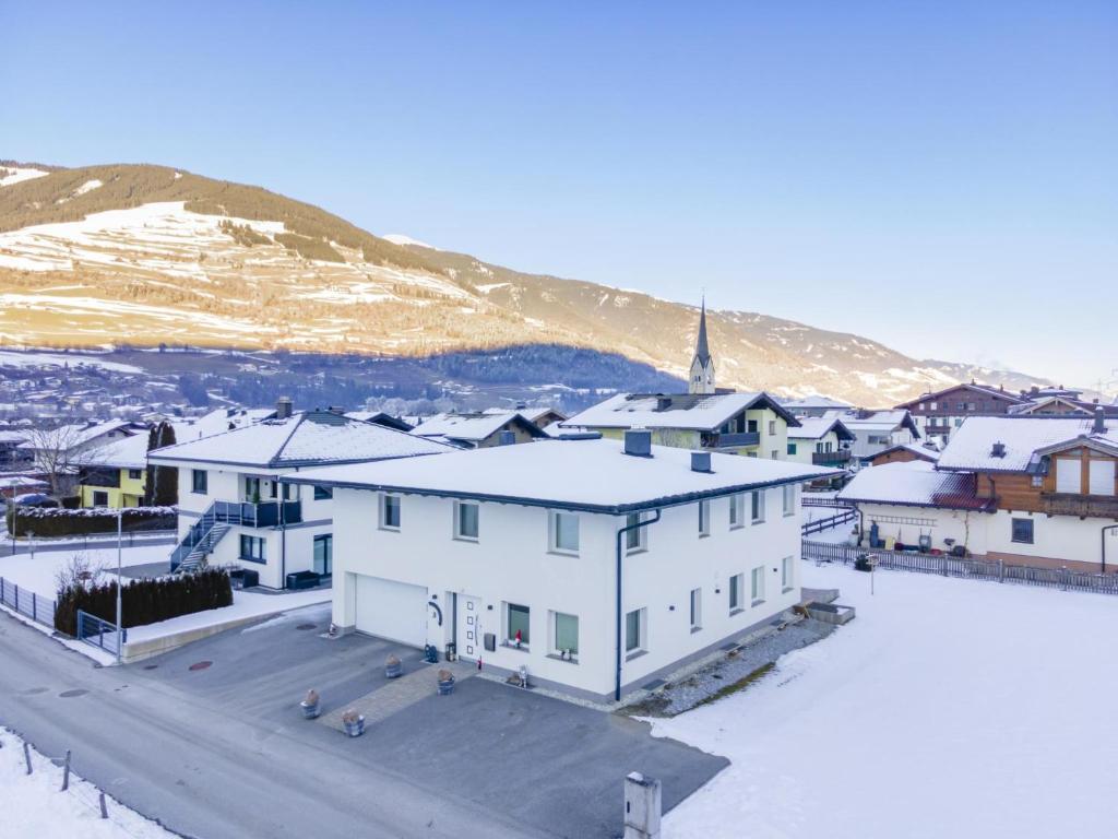 a town with snow covered buildings and a mountain at Karo in Mittersill