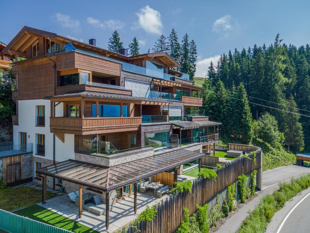 a house with wooden balconies on a hill at Kitzbüheler Alpenlodge Top A8 in Mittersill