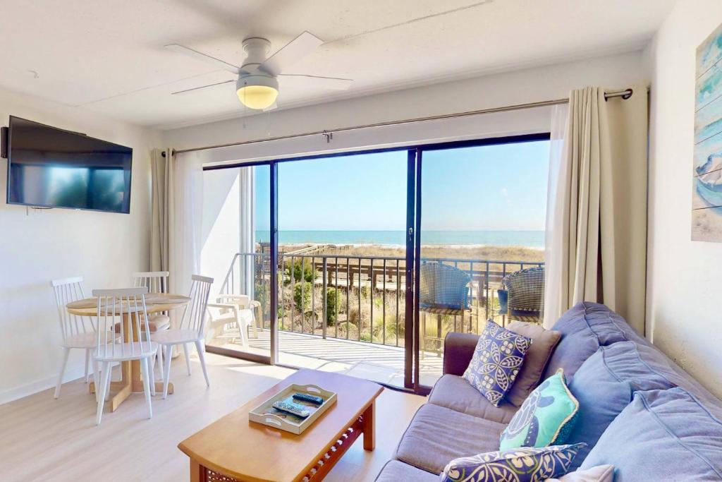 a living room with a couch and a table at Casa Al Mare in Carolina Beach