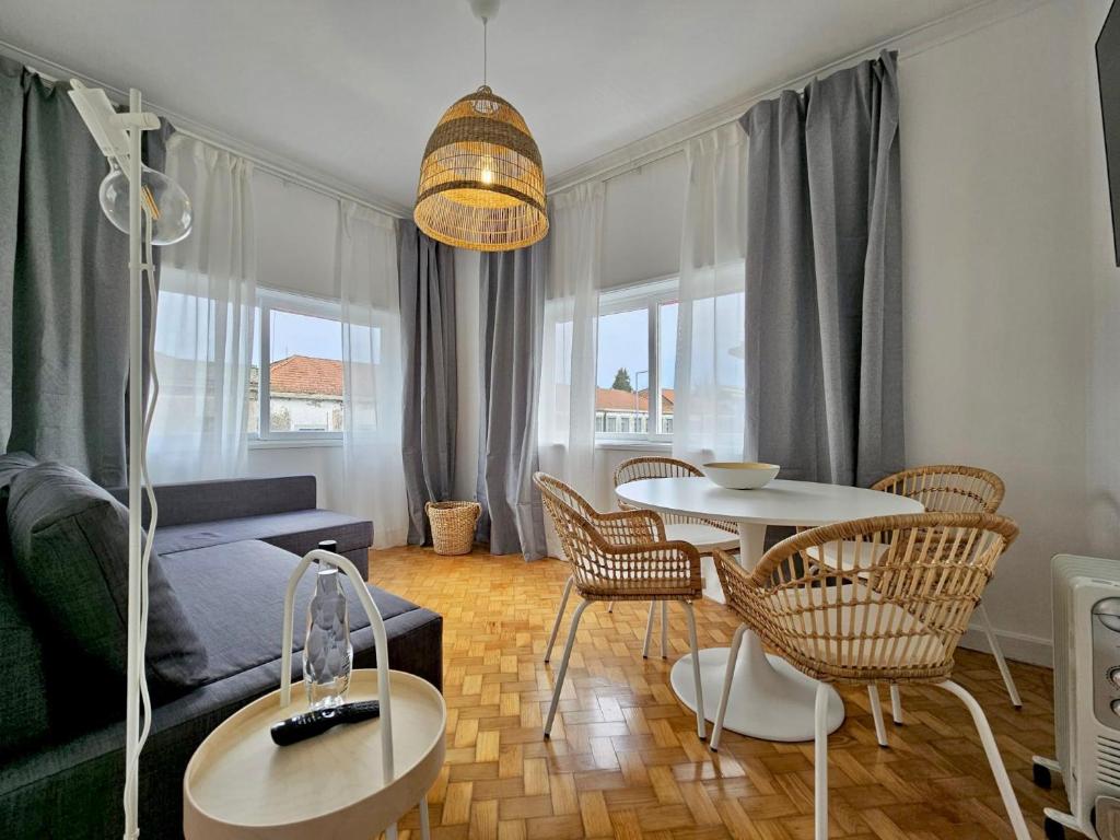 a living room with a couch and a table and chairs at LM art apartments in Porto