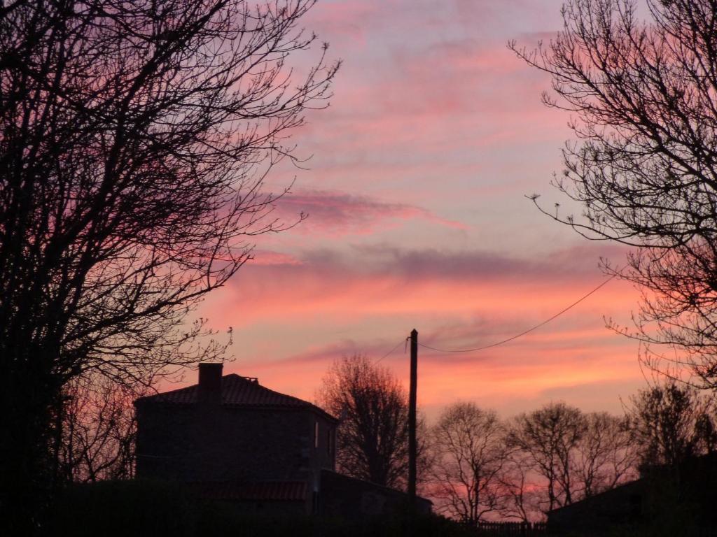 a sunset in the sky with trees and a building at Gîte Le Bernard, 6 pièces, 10 personnes - FR-1-426-164 in Le Bernard