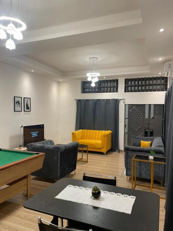 a living room with couches and a pool table at Timba chic-villa in Abomey-Calavi