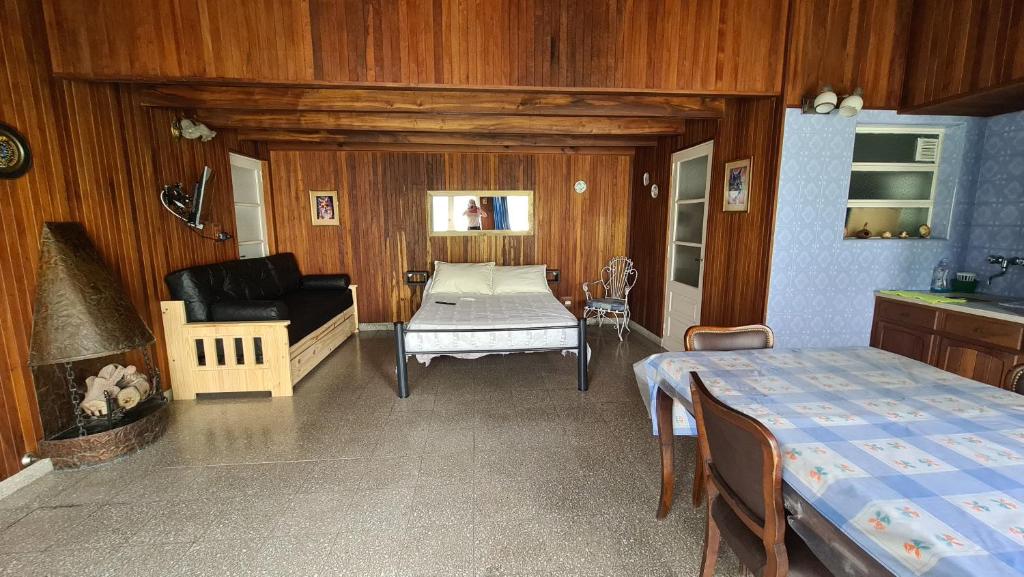 a room with a bed and a couch and a table at Monoambiente Cañuelas Centro calle Principal hasta 4 personas in Cañuelas