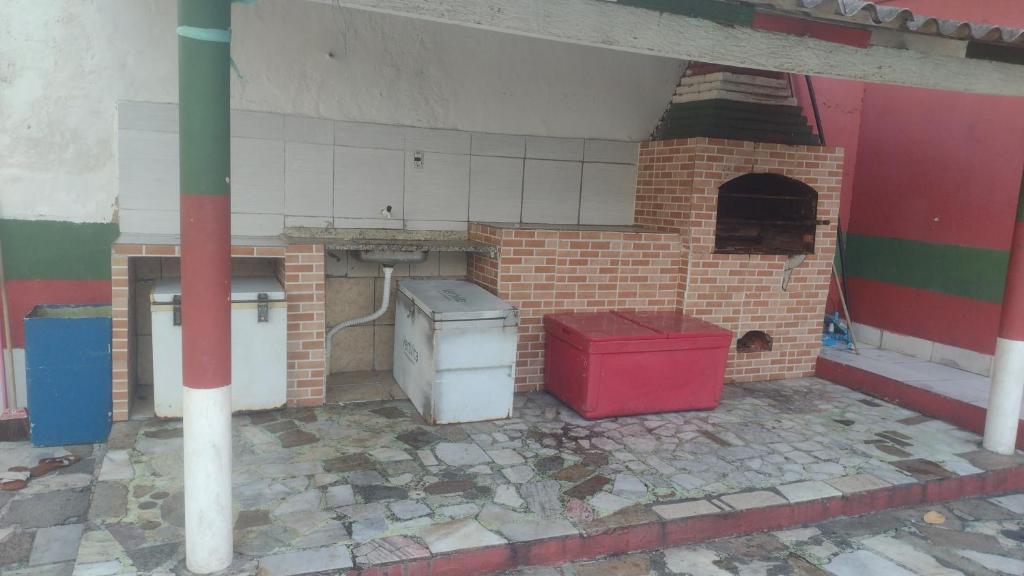 a kitchen with a stove and a brick oven at Bitencourt in Rio de Janeiro