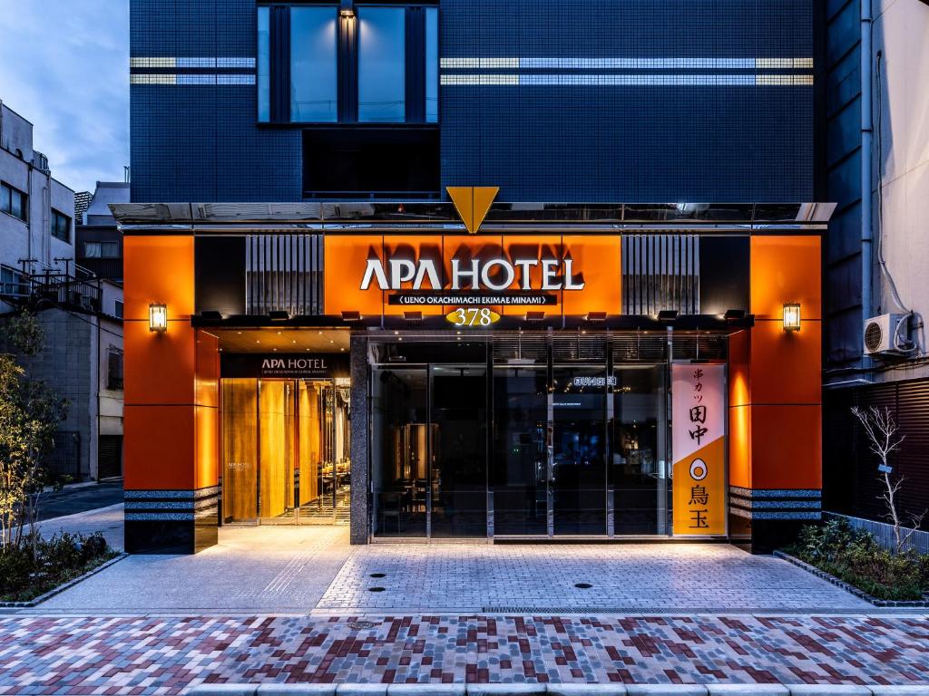 an entrance to an apán hotel in a city at Apa Hotel Ueno Okachimachi Ekimae Minami in Tokyo