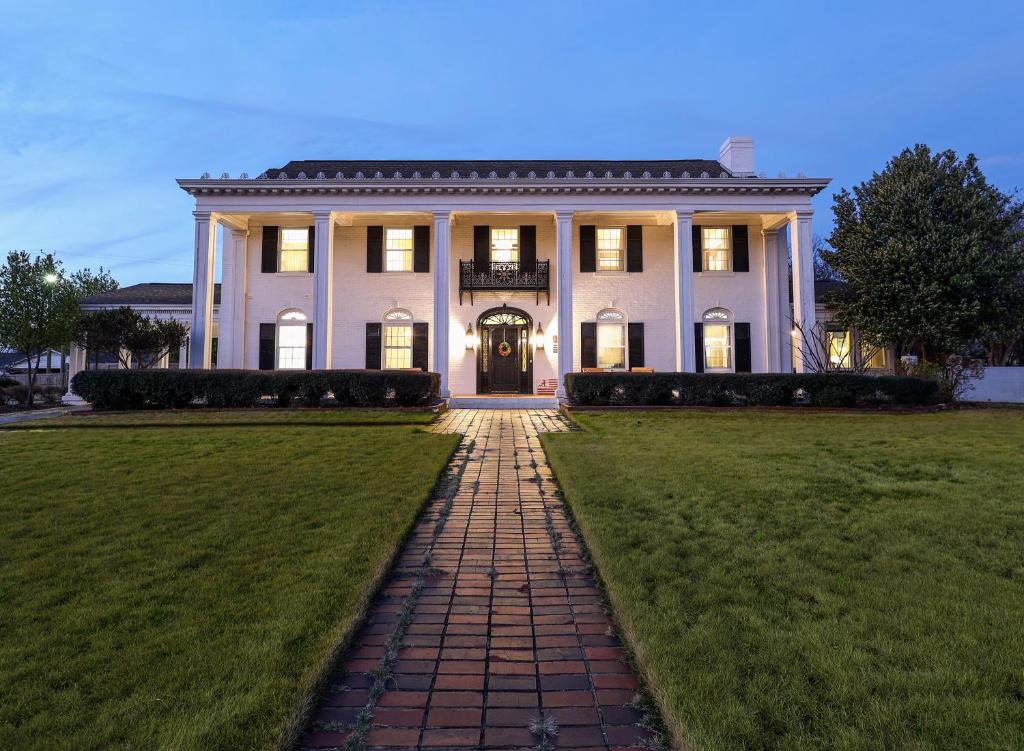 a large white house with a pathway in front of it at Wood Manor Guest House in Tuscaloosa