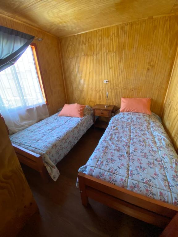 Postel nebo postele na pokoji v ubytování Hostal Coronel Riffo