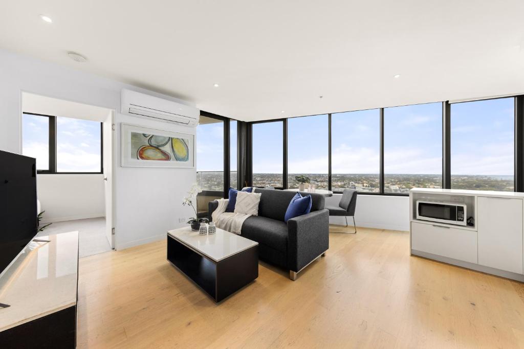 a living room with a couch and a table at Convenient Located 1bedroom apartment in St Kilda in Melbourne
