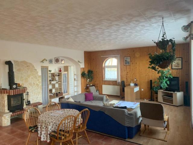 uma sala de estar com uma cama, uma mesa e cadeiras em Érd - Csendes, kényelmes családi ház em Érd