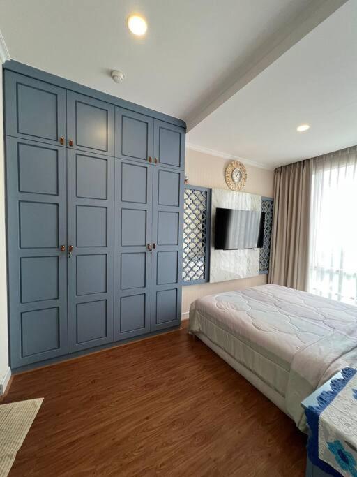 a bedroom with a large bed and a large closet at SWSB Home — 3BR Apartment in Jakarta City Centre in Jakarta