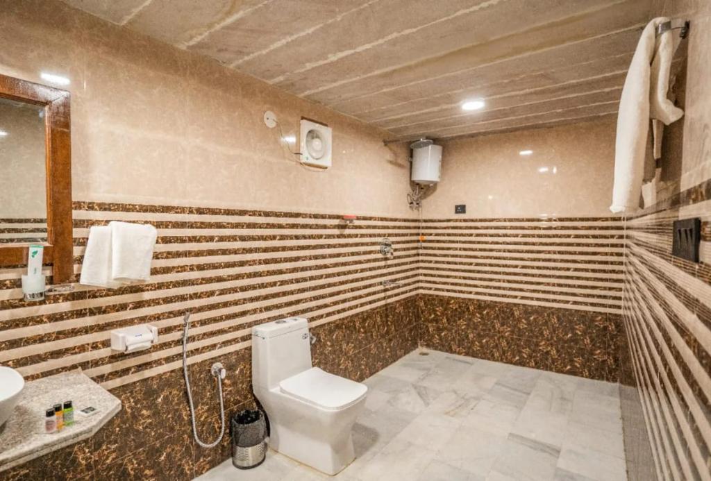 a bathroom with a toilet and a sink at Desert galaxy resort in Jaisalmer