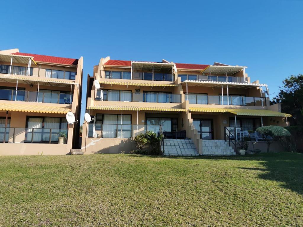 an apartment building with a lawn in front of it at Summer Place 36 in Margate