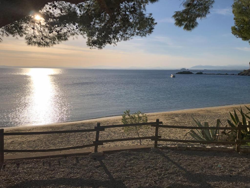 a bench sitting on the beach near the water at Veuràs el Mar - Madrague Beach Studio 25 in Roses