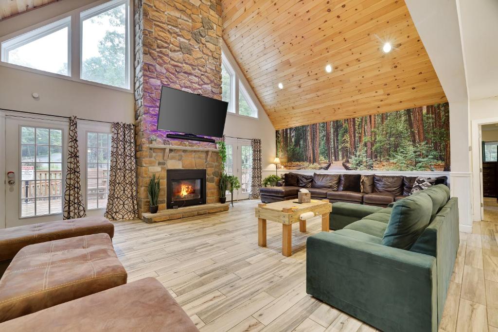 a living room with a couch and a fireplace at Lagniappe Lodge Spa, Views, Life Memories in Tafton