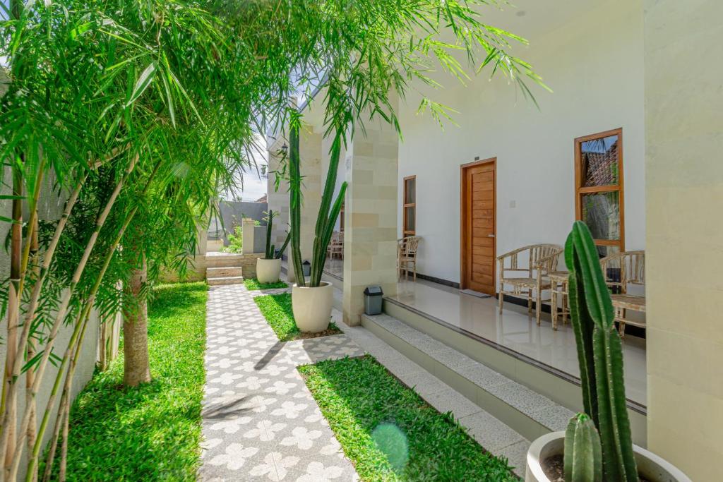 a courtyard with trees and plants in a house at Seven Angels Villa and Hostel in Nusa Penida