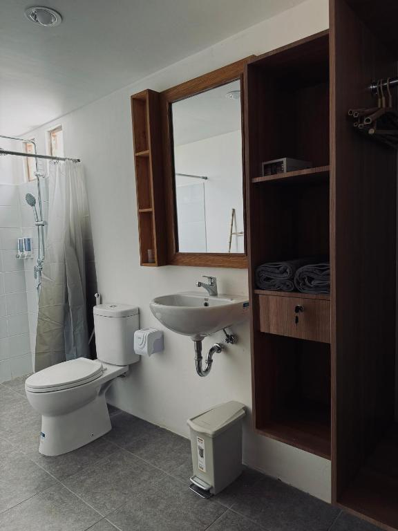 a bathroom with a toilet and a sink at Uma Pantai Seseh in Canggu