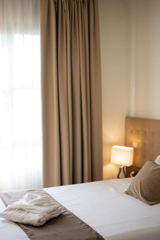 Postel nebo postele na pokoji v ubytování Charme Hotel