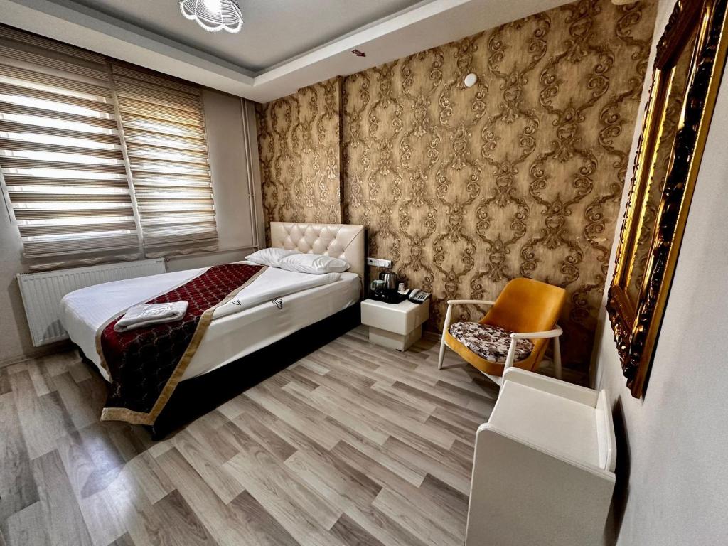 a bedroom with a bed and a chair at HOTEL SEVEN PARK in Nevsehir