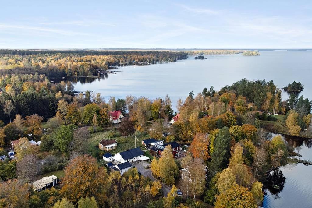 an aerial view of a lake with trees and houses at Holiday home in Växjö