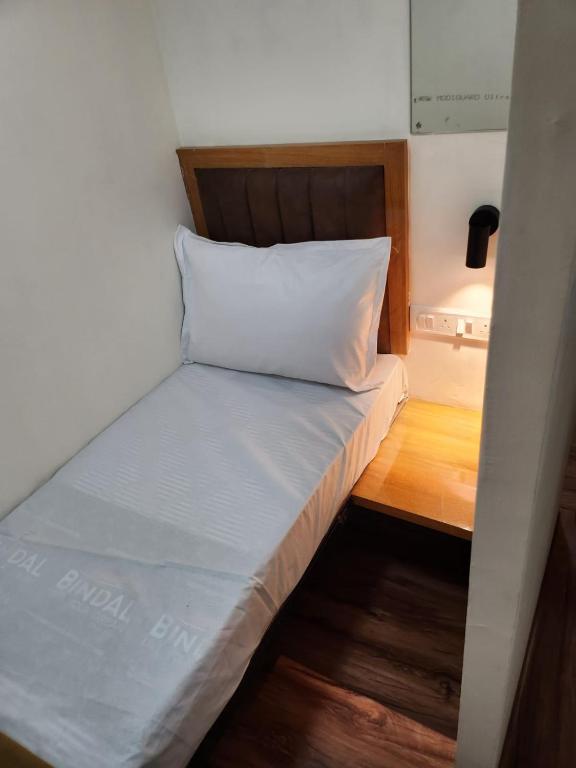 a bed in a small room with a pillow on it at Galaxy Cabin Stay And Dormitory in Mumbai