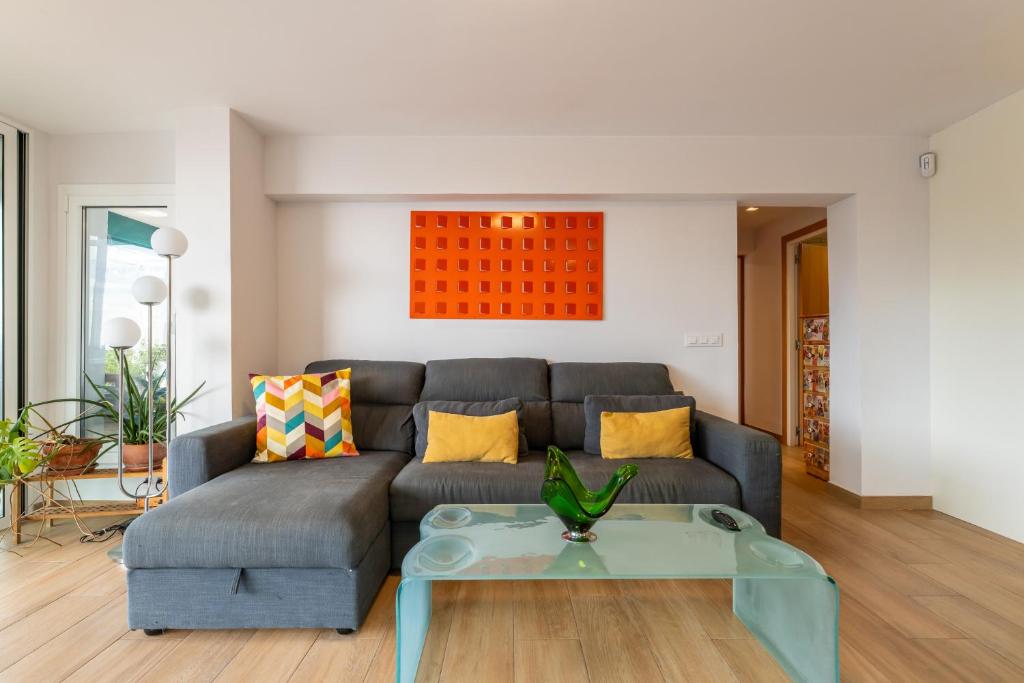 a living room with a couch and a table at Luxury Designer Beach Front Two Bedroom Apartment in Salou