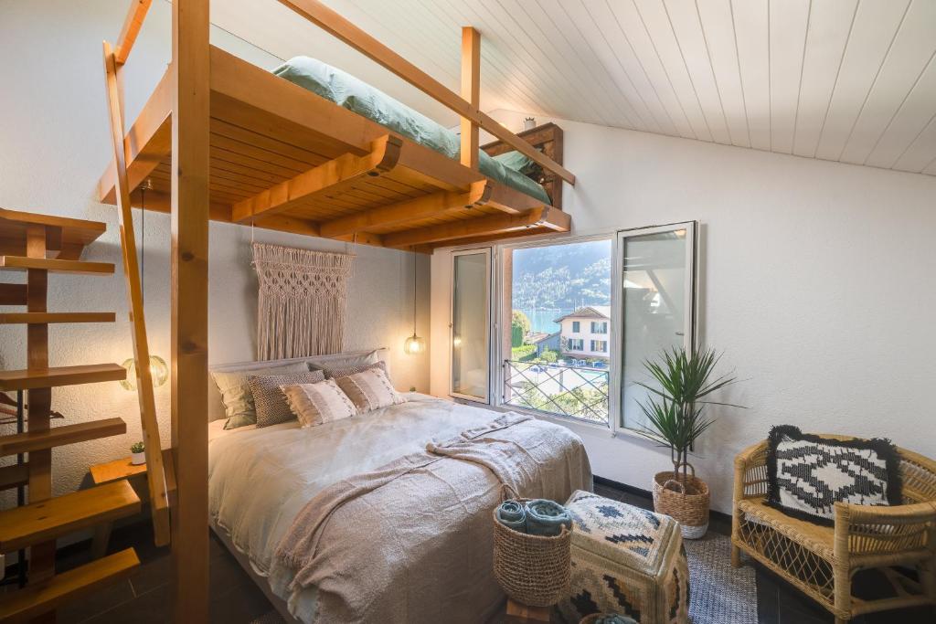 a bedroom with a bunk bed and a staircase at Bijou du Lac - mit Pool und Privatstrand in Därligen