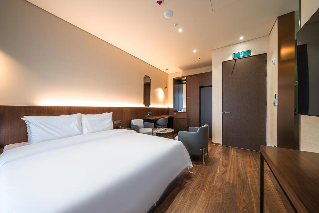 Postel nebo postele na pokoji v ubytování Uiwang Milos Hotel