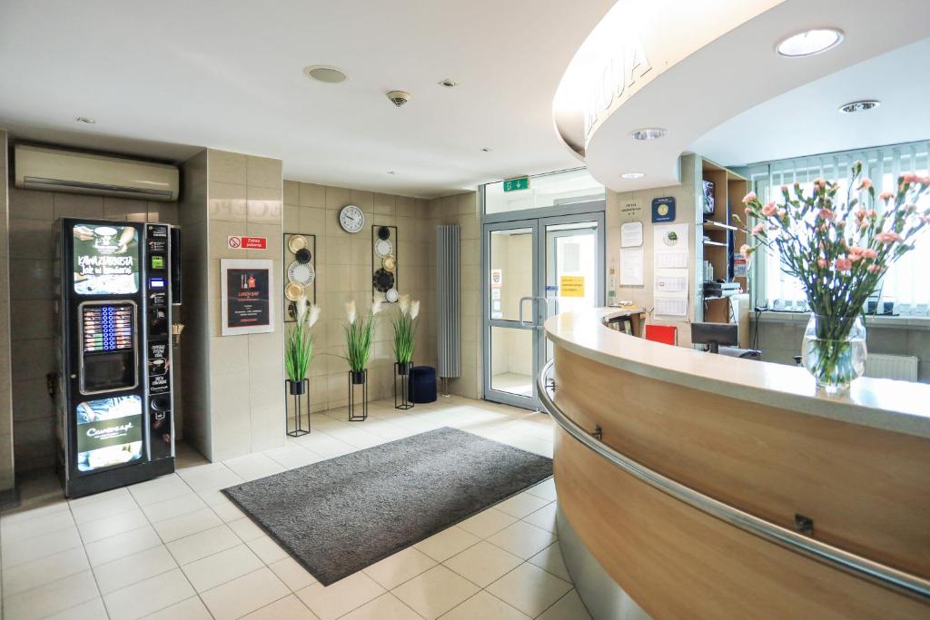 a fast food restaurant with a cash register and a counter at Hotel Krakowiak in Krakow