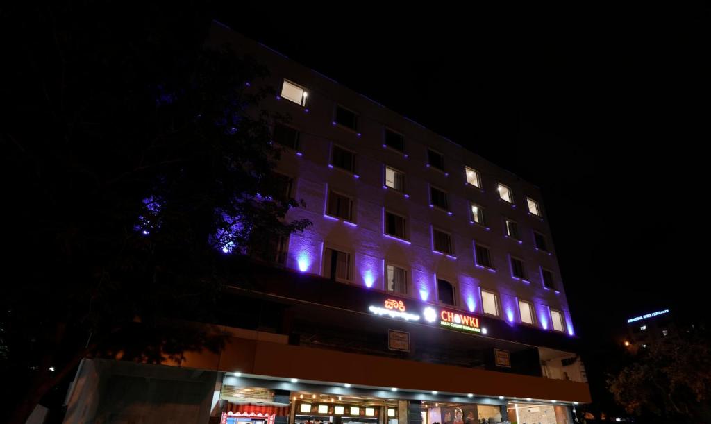 a building with purple lights on it at night at Happy Stays Whitefield in Bengaluru