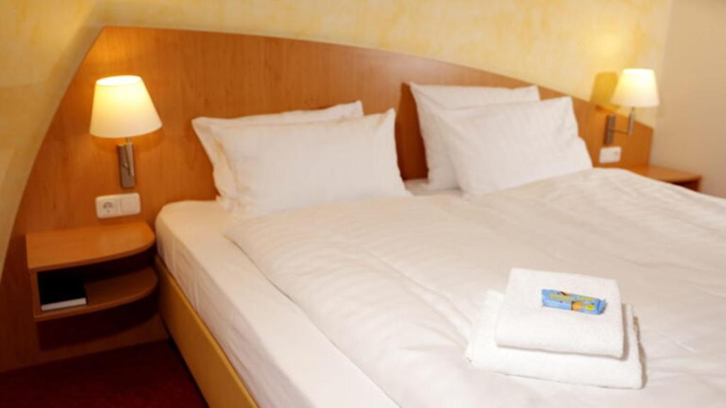 Postel nebo postele na pokoji v ubytování Hotel Alarun