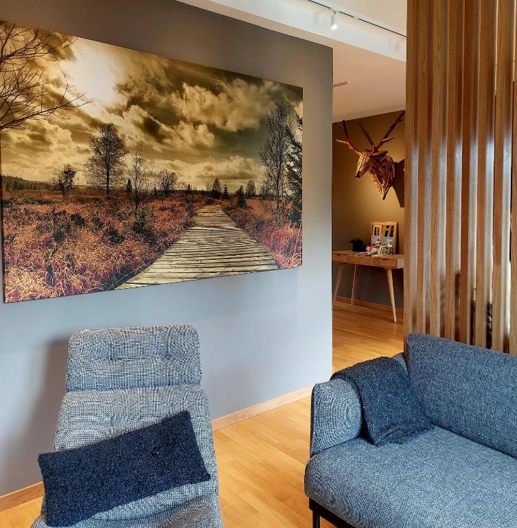 a living room with a painting on the wall at Au Cerf & Fagnes in Spa