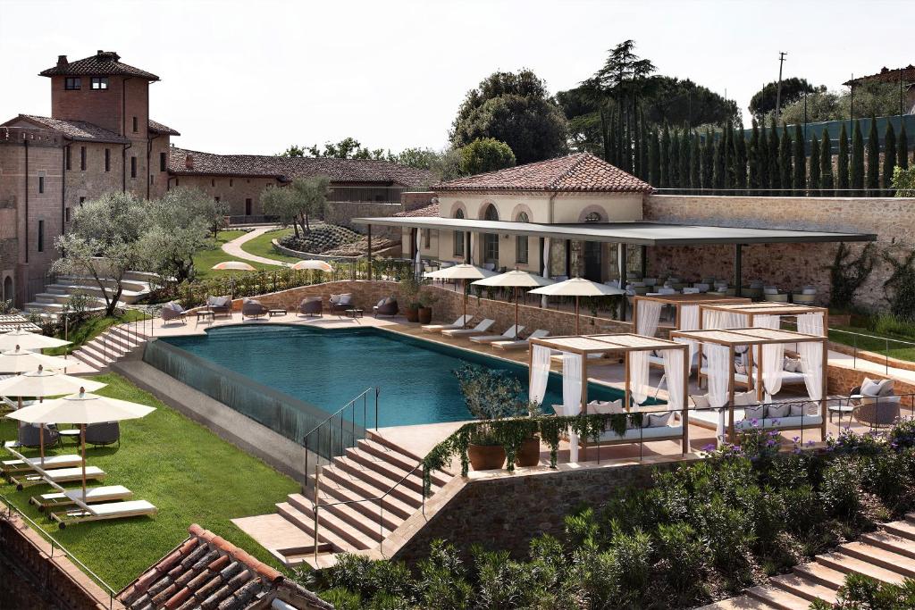 an aerial view of a house with a swimming pool at Borgo Dei Conti Resort Relais & Chateaux in Monte Petriolo