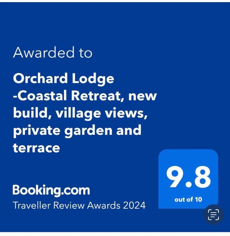 a screenshot of a cell phone with the words upgraded to ontario lodge coastal retreat at Orchard Lodge -Coastal Retreat, new build, village views, private garden and terrace in Saint Brides Major