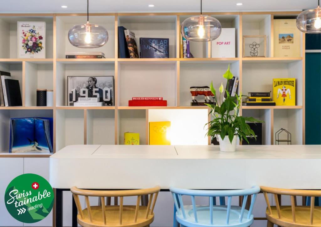 a counter in a store with four chairs at ibis budget Genève Petit-Lancy in Geneva