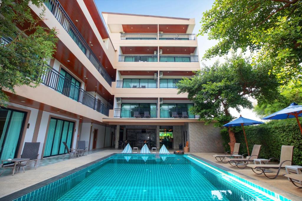 una piscina di fronte a un edificio di The Bell Airport Phuket Hotel - SHA Extra Plus a Nai Yang Beach