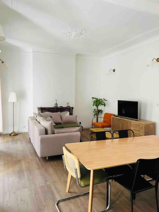 a living room with a table and a couch at Le Capucin - Au coeur de Marseille in Marseille