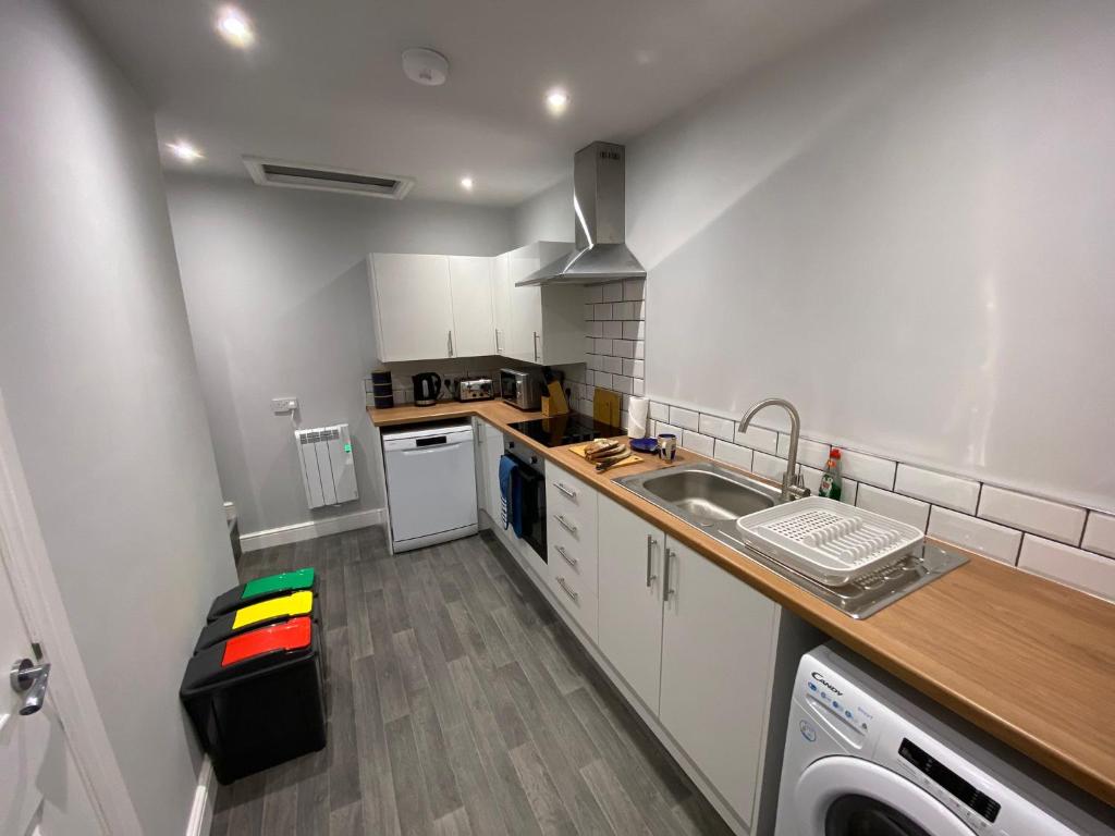 a small kitchen with a sink and a dishwasher at Maritime House One - Hull in Hull