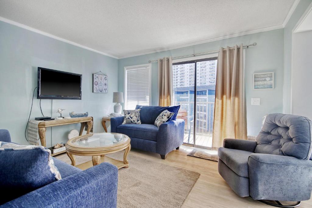 a living room with blue furniture and a tv at Myrtle Beach Resort A430 in Myrtle Beach