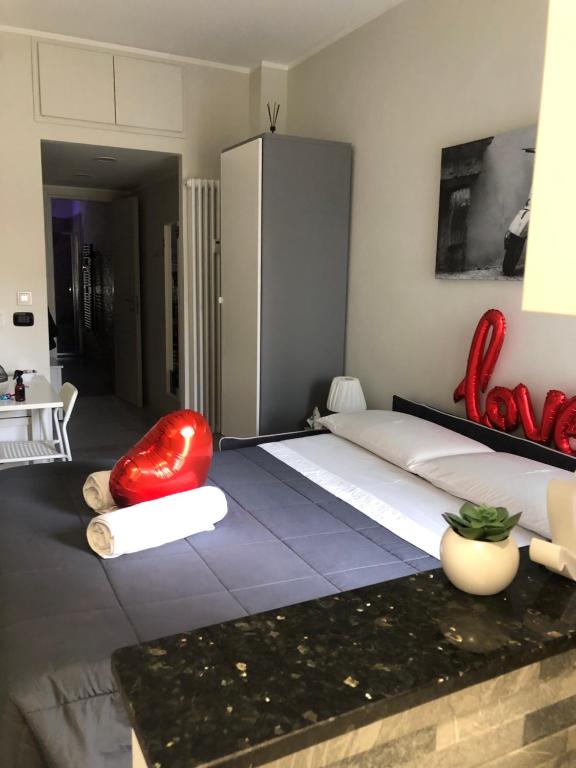 a bedroom with a large bed with a red chair at Maremma10 in Turin