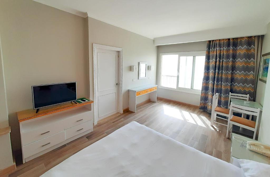 Postel nebo postele na pokoji v ubytování Beau Site Hotel