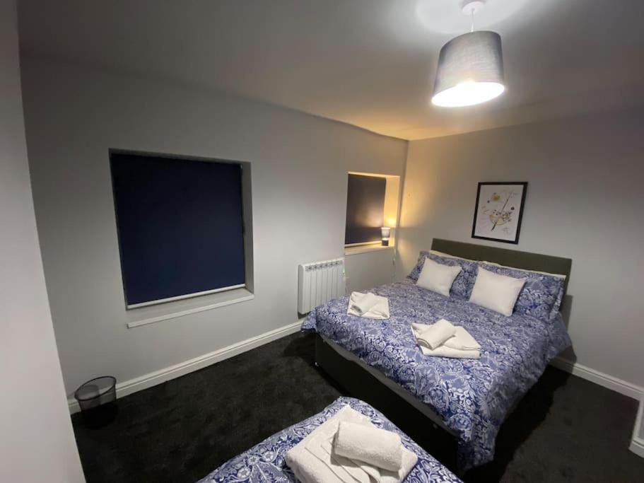 a bedroom with two beds and a flat screen tv at Maritime House Two in Hull