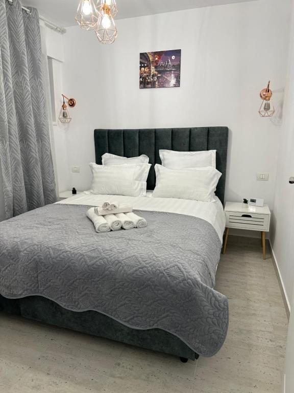 a bedroom with a large bed with two towels on it at Apartament Bonton Predeal in Predeal