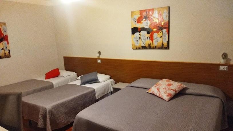 Postel nebo postele na pokoji v ubytování Nuovo Hotel Giardini