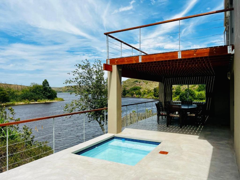 a house with a balcony with a swimming pool at Malgas 168 - Kom Binne Home in Malgas