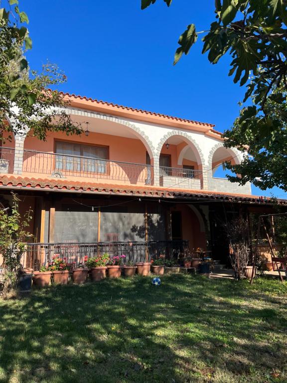 a large house with a balcony and a yard at Athina Villa in Zilotí