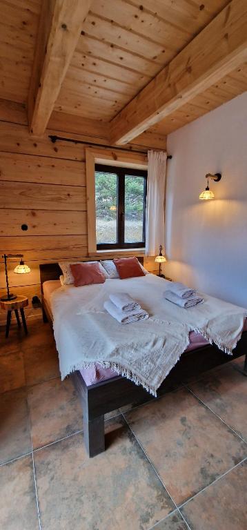 a bedroom with a large bed in a cabin at Apartamenty komu gloria in Wetlina