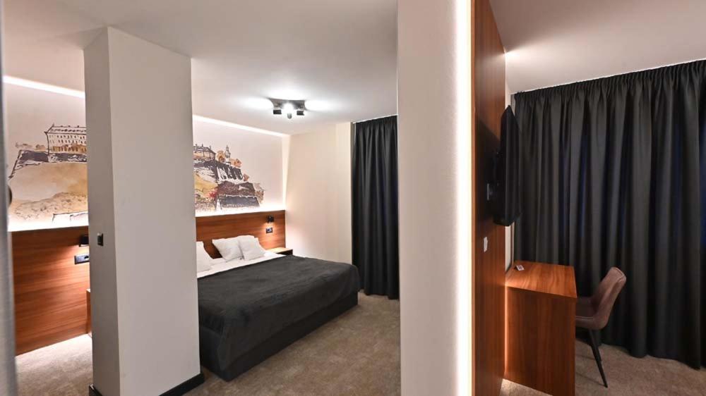 Postel nebo postele na pokoji v ubytování Tvrdjava Rooms - Novi Sad