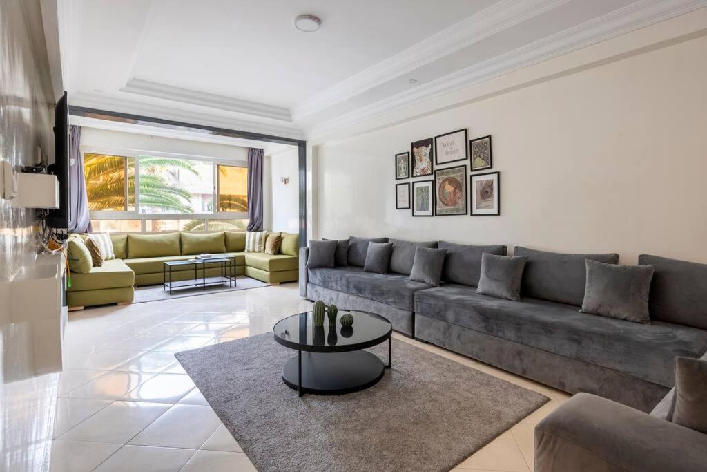 a living room with a couch and a table at TT Holidays - Rabat City Center in Rabat
